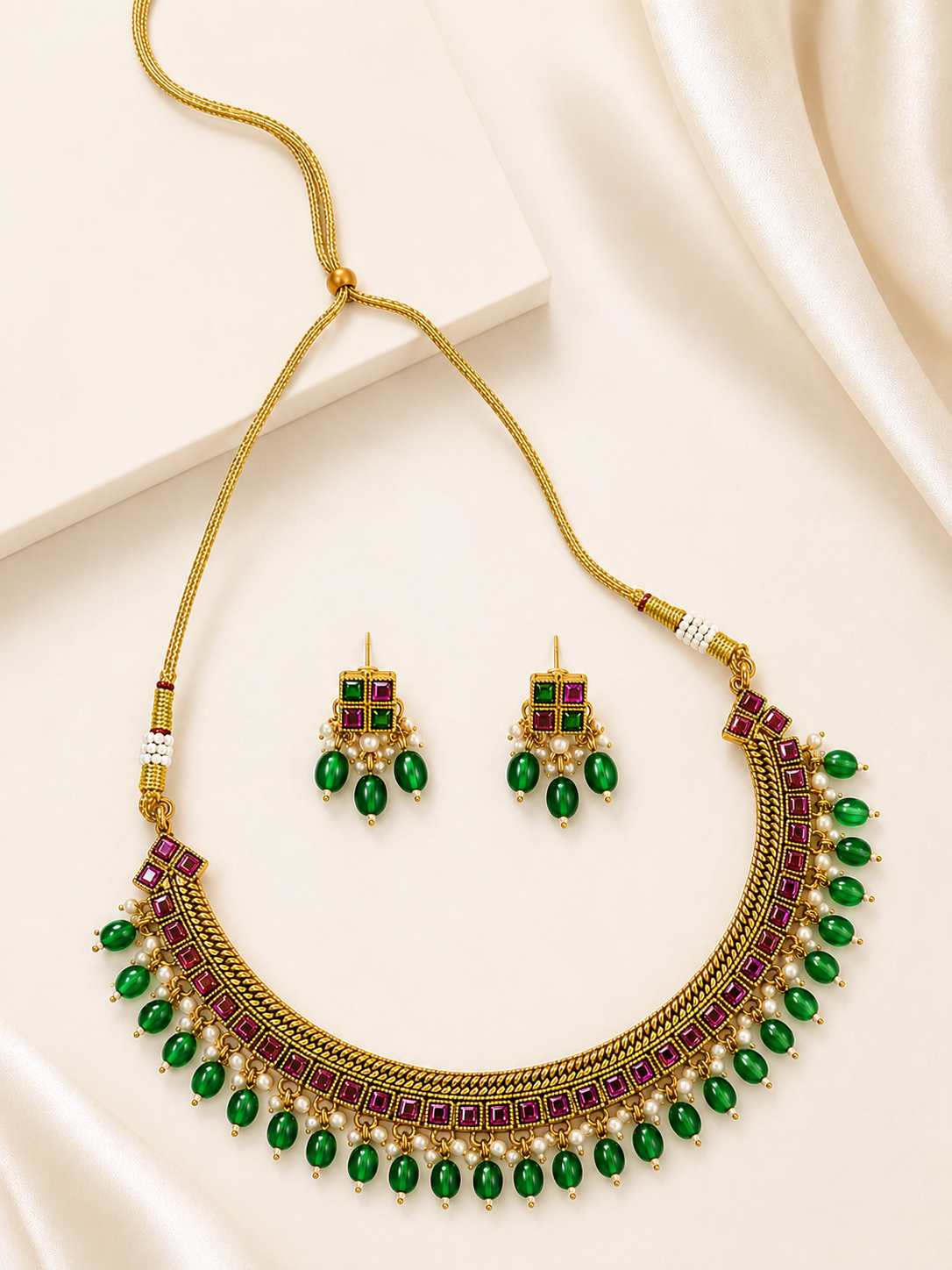 Emerald green and ruby red choker necklace set with pearl drops and matching earrings in antique gold tone