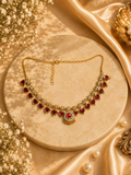 Traditional Palakka necklace with red stones on marble display