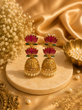 Double lotus jhumka earrings with pearl drops on marble display