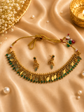 Antique gold Elakathali necklace set with green stones and mango drops on silk