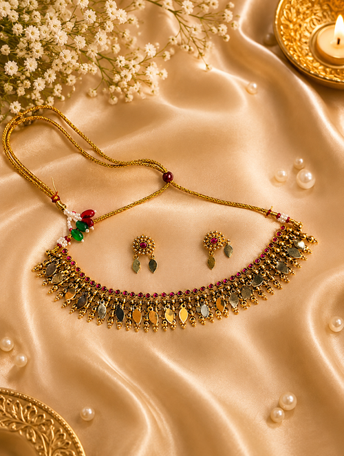 Antique gold Nagapadam necklace set with ruby stones and leaf drops on silk