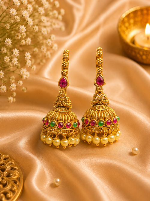 Antique gold peacock jhumka earrings with ruby emerald stones and pearl drops