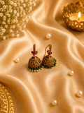 Antique gold filigree jhumka earrings with green beads and pearl drops on silk
