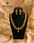 Gold CZ Floral Necklace and Earring Set in antique gold tone on black jewellery bust