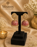 Mauve Meenakari Jhumka Earrings with gold lattice kundan work and pearl drops on black earring stand