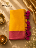Mustard-yellow mul cotton saree with a magenta border and matching tassels
