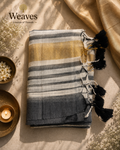 Black and grey striped mul cotton saree with a warm gold-toned border and black tassels