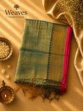 Teal soft tissue saree with a black and golden pallu, pink border, and tassel details