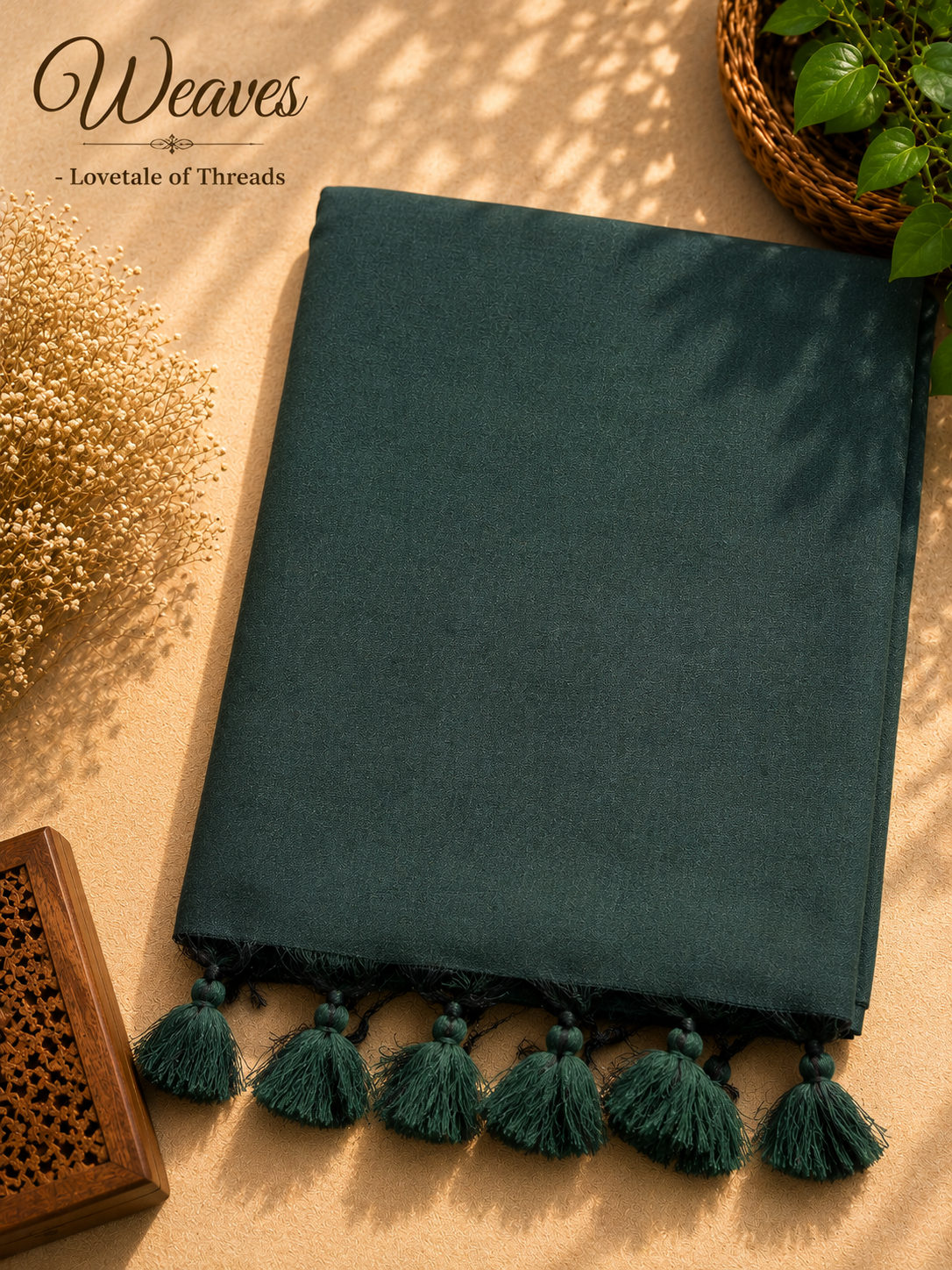 Folded emerald green silk tissue saree with green tassels