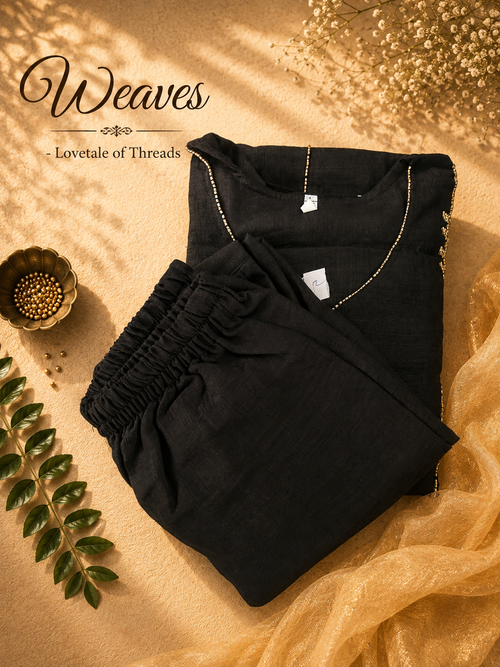 Black Aline top and pant set with coordinated pants and gold-toned detailing