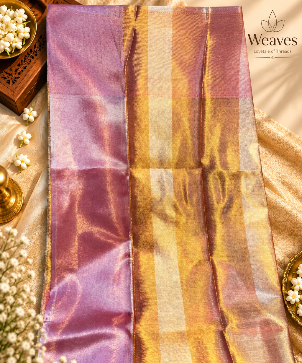 Model wearing a dual-tone gold and pastel pink semi tissue silk saree