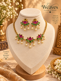 Pink floral necklace and matching earrings set with green leaf accents and pearl-like drops