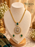 Green teardrop necklace and matching earrings jewellery set on a display bust
