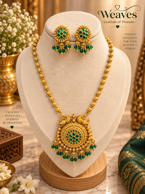 Antique gold peacock necklace set with green stones and beads