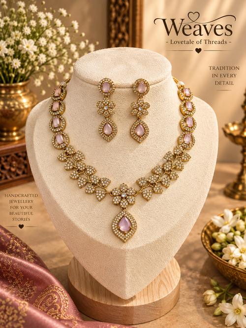 Victorian gold necklace set with blush pink stones, floral clusters, and matching long earrings