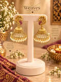 Antique gold peacock jhumka earrings with white stone work and pearl drop fringe