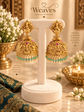 Antique gold Lakshmi temple jhumka earrings with pink stones and mint green bead drops