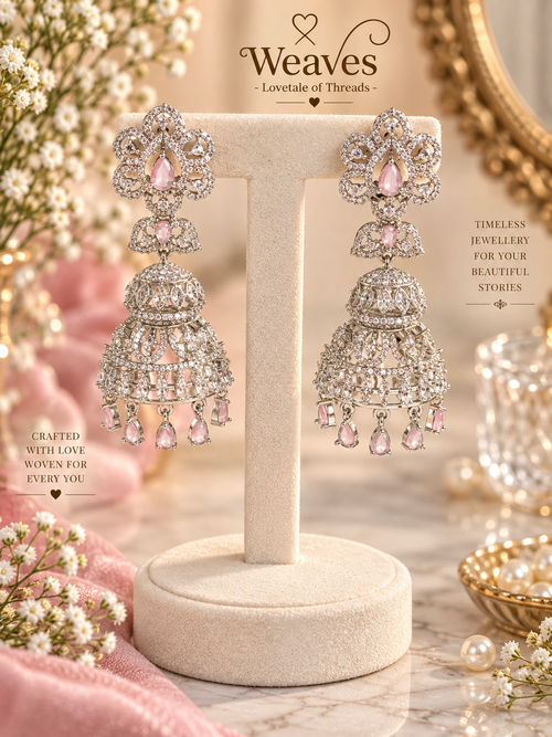 Silver-tone American diamond jhumka earrings with blush pink stones and tiered drops