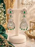 Silver-tone American diamond jhumka earrings with emerald green stones and tiered drops