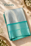 Folded silver grey tissue silk saree with turquoise temple border