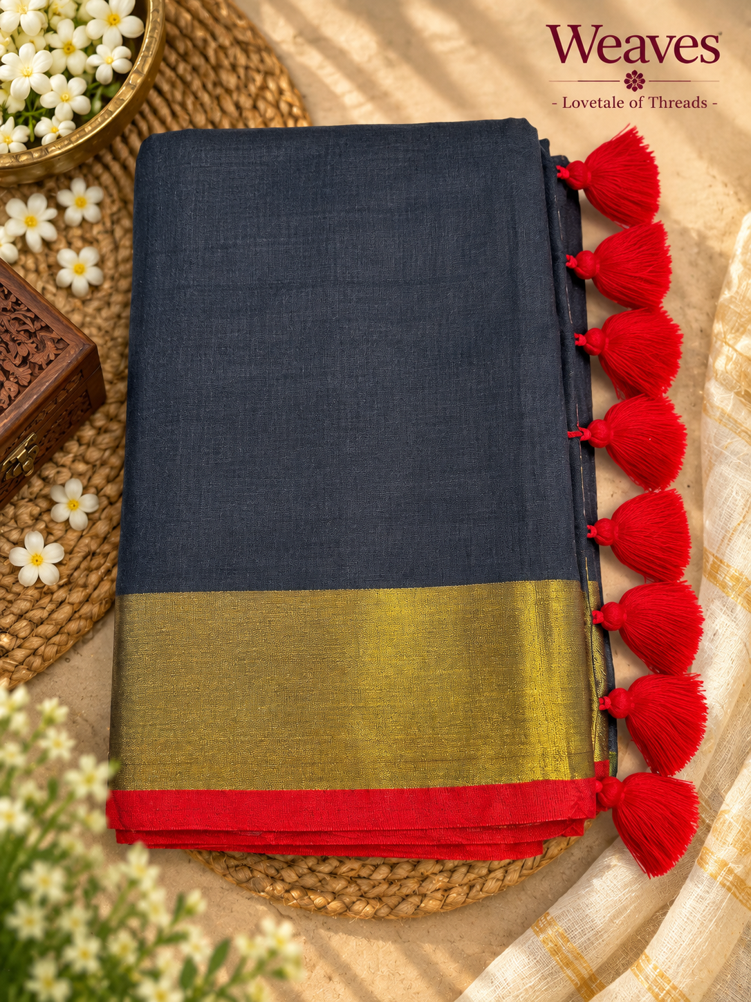 Navy blue mul cotton saree with mustard-gold-toned and red border and bright red tassels