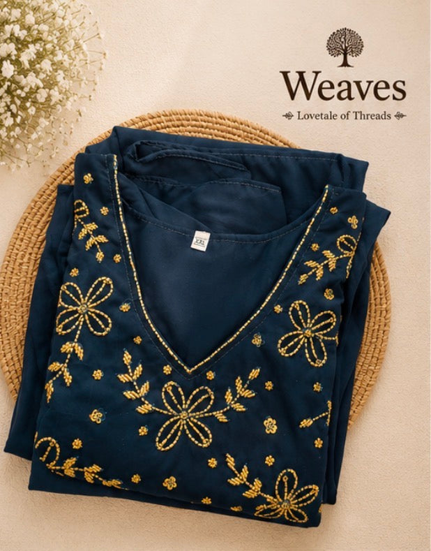 Georgette Umbrella Top in navy blue with gold floral embroidery on rattan tray